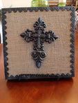 Wrought Iron Cross surrounded by wood Iron and burlap. 10×10